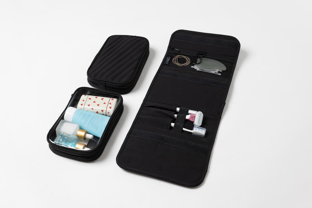 Black travel organizer with compartments on a white background